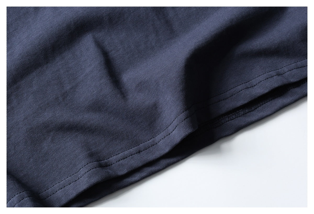Close-up of the dark navy T-shirt's double-stitched bottom hem.