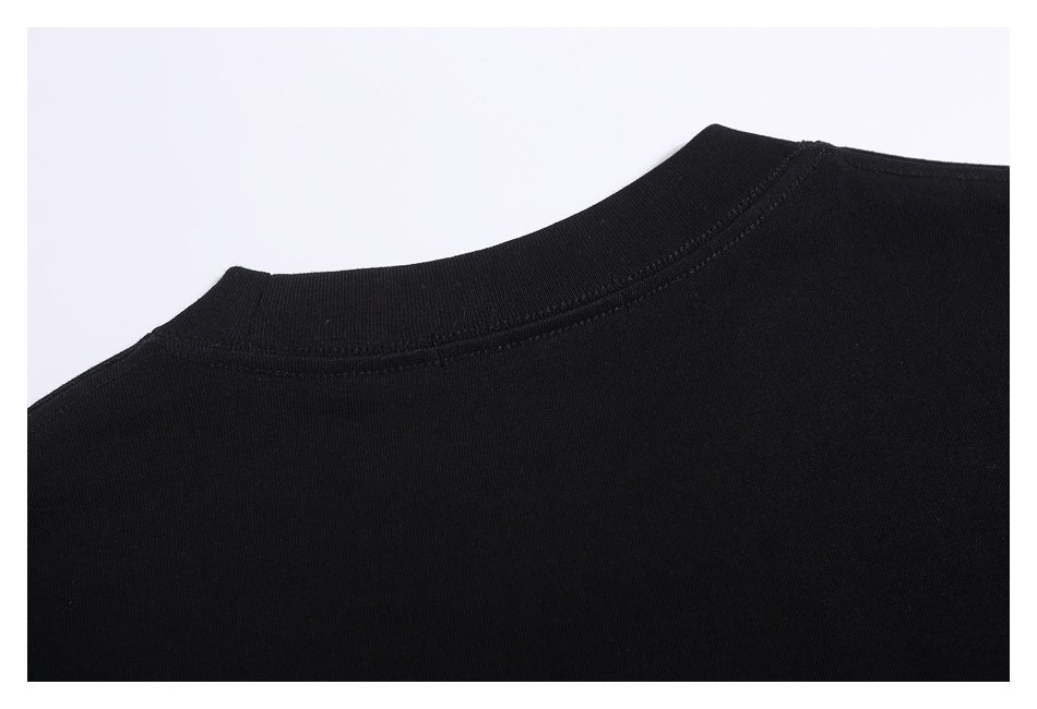 Close-up of a black T-shirt's crew neckline and shoulder seams.