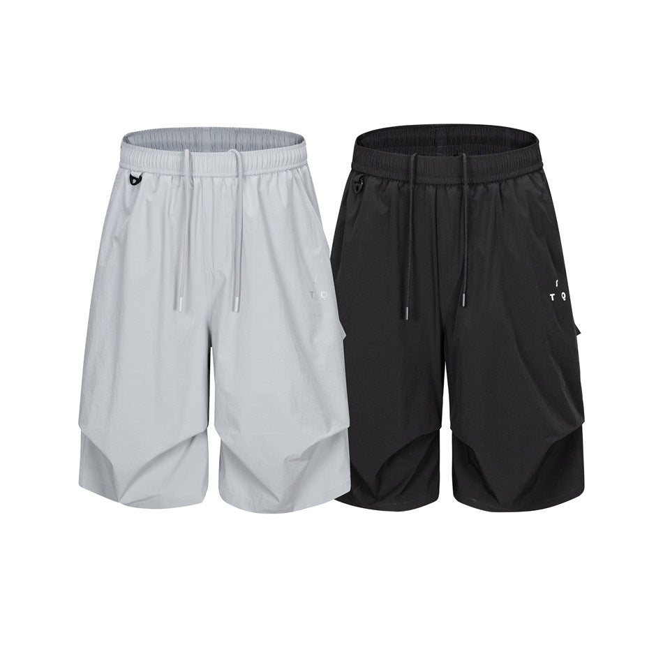 Front view of loose knee-length shorts in light gray and black, both with elastic drawstring waists and small leg marks.