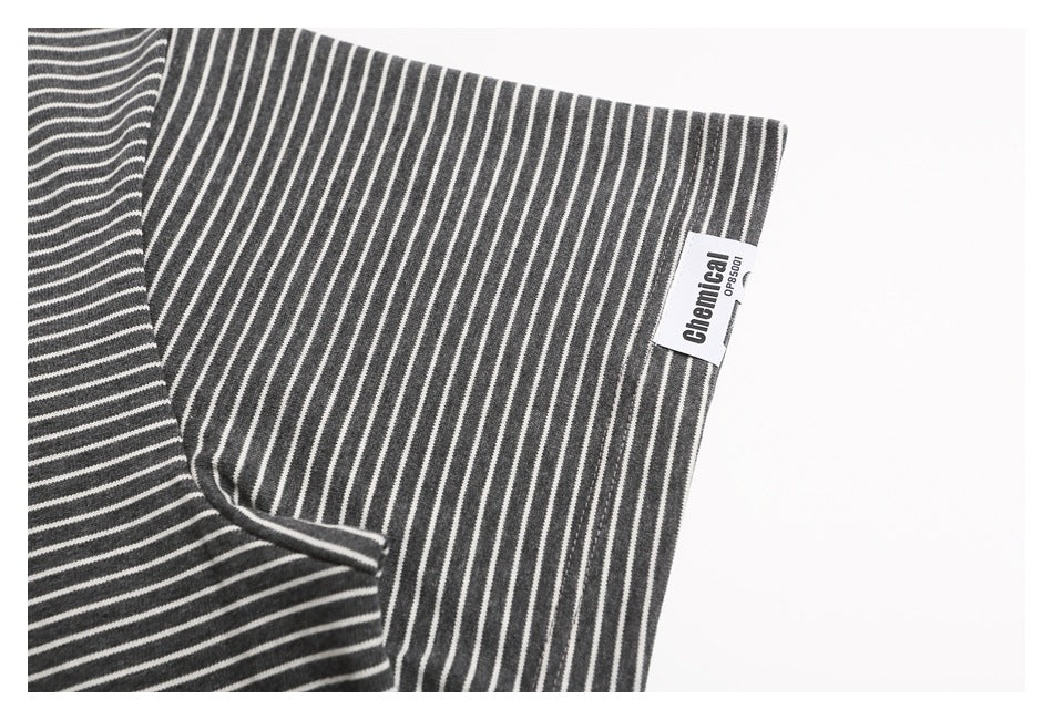 Close-up of the striped shirt's sleeve edge and side seam, with a small brand tag.
