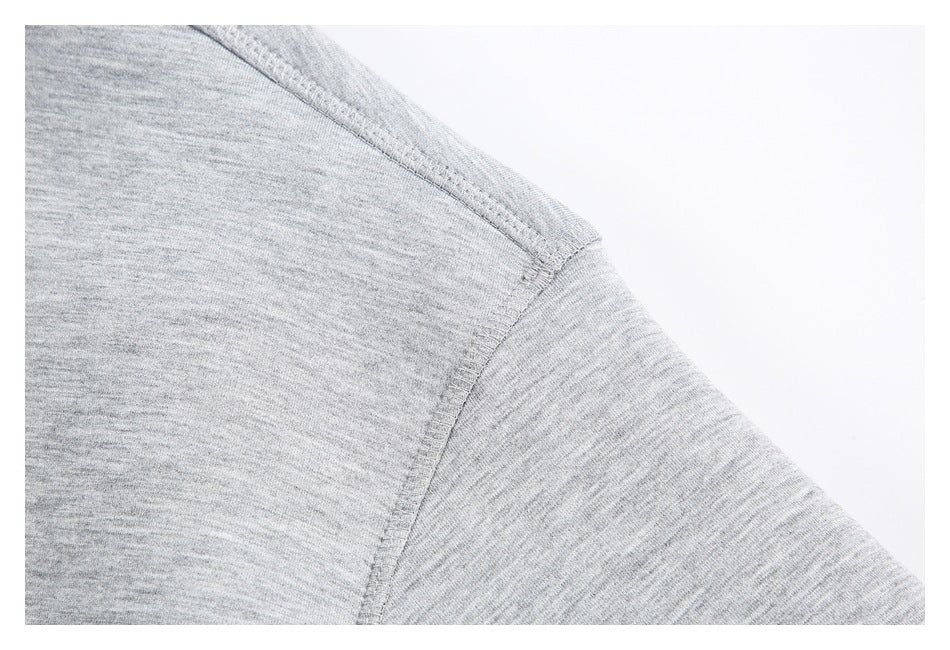 Close-up of a gray heather sweatshirt shoulder seam and sleeve.