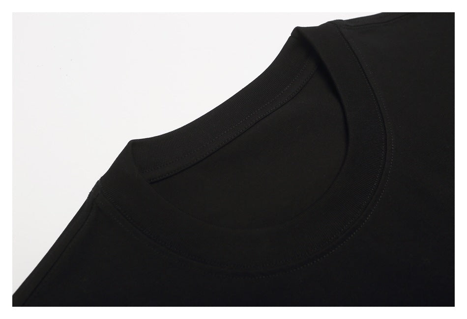 Close-up of the black T-shirt's ribbed crew neckline and shoulder seam.