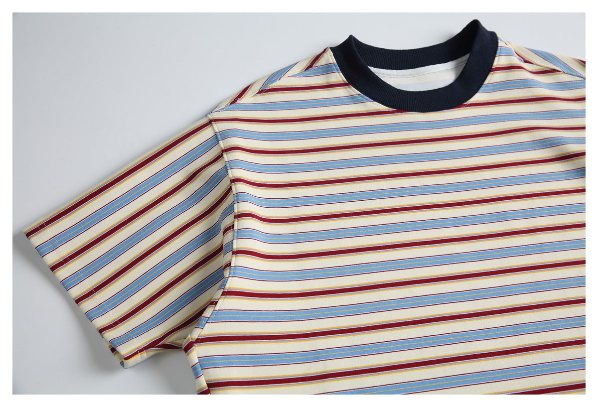 Front view of a cream short-sleeve T-shirt with blue and burgundy horizontal stripes and a dark ribbed crew neck.