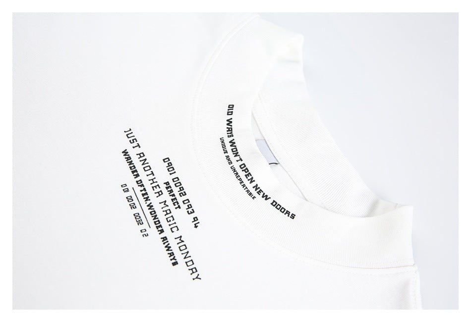 Close-up of a white T-shirt's ribbed collar and small black English text printed on the chest and collar.