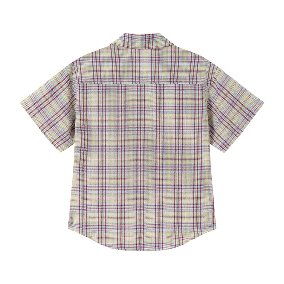 Flat-lay back of a short-sleeve multicolor plaid shirt showing the yoke seam and curved hem