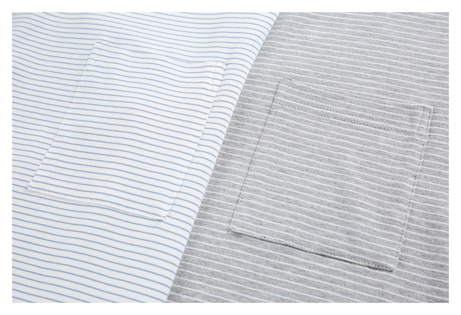 Close-up of chest pockets on white-and-blue-striped and gray-and-white-striped T-shirts.