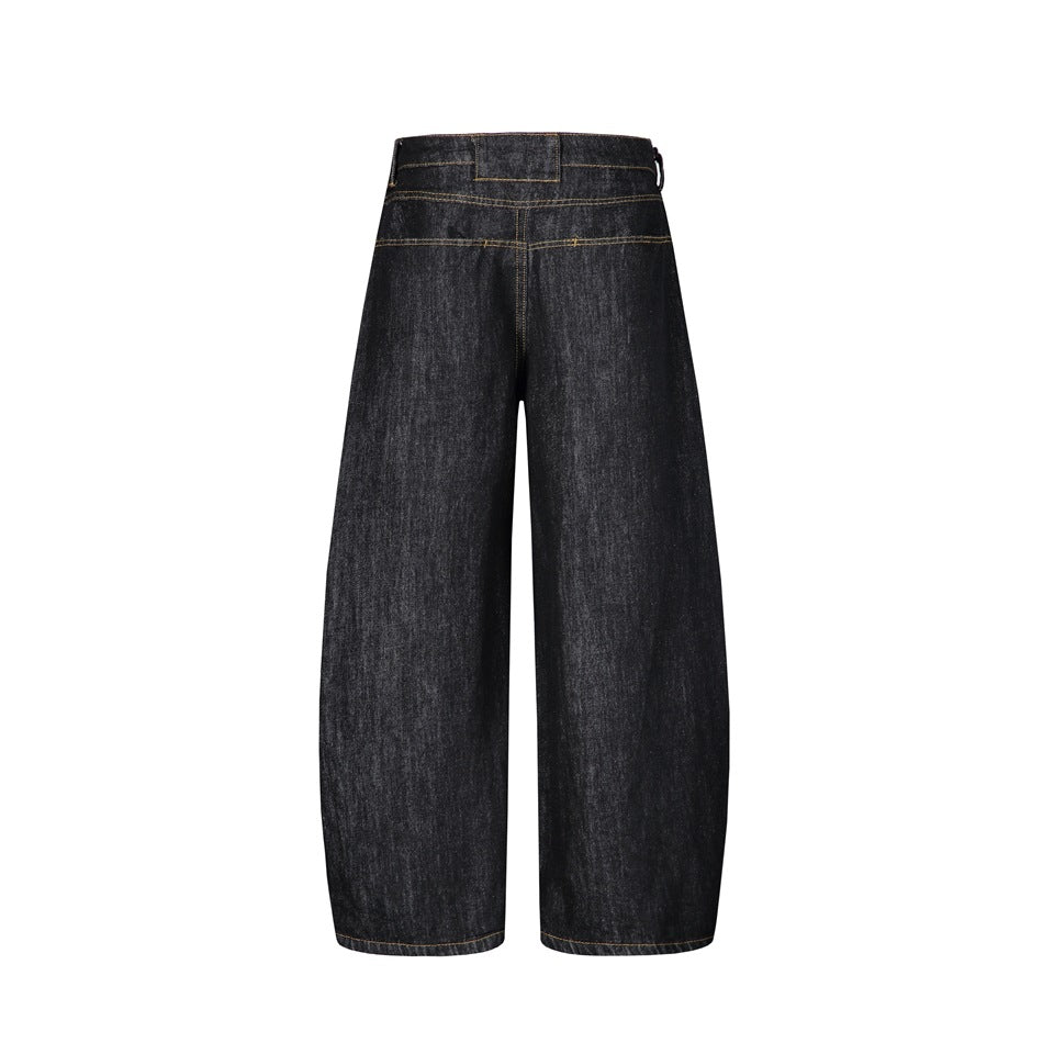 Back view of washed black wide-leg barrel jeans with yoke seam, waistband panel and golden topstitching