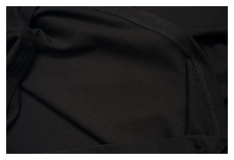 Close-up of the black shirt's interior fabric and overlocked seam.