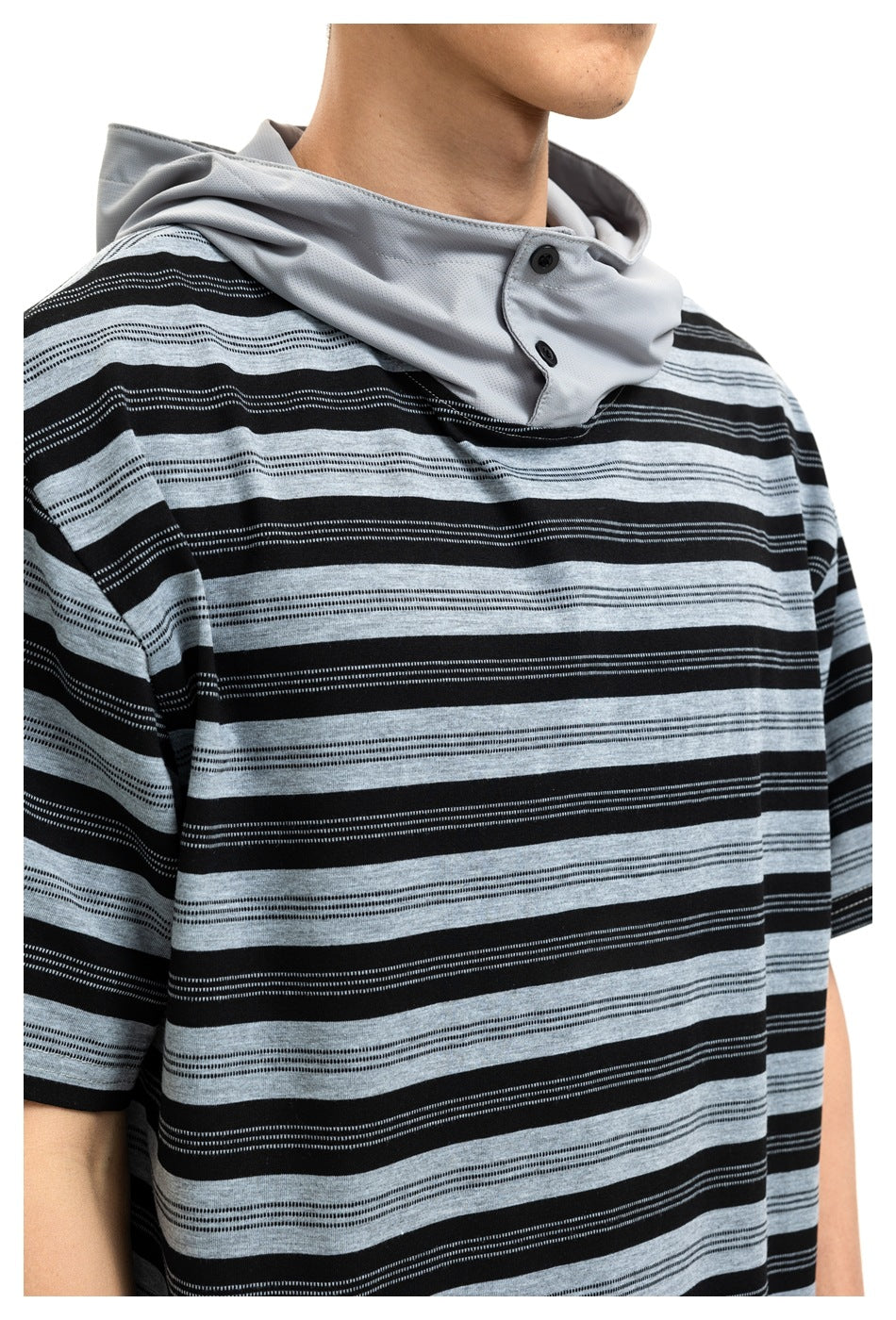Close-up of the top's black and gray horizontal stripes and light gray hood panel with two black buttons.