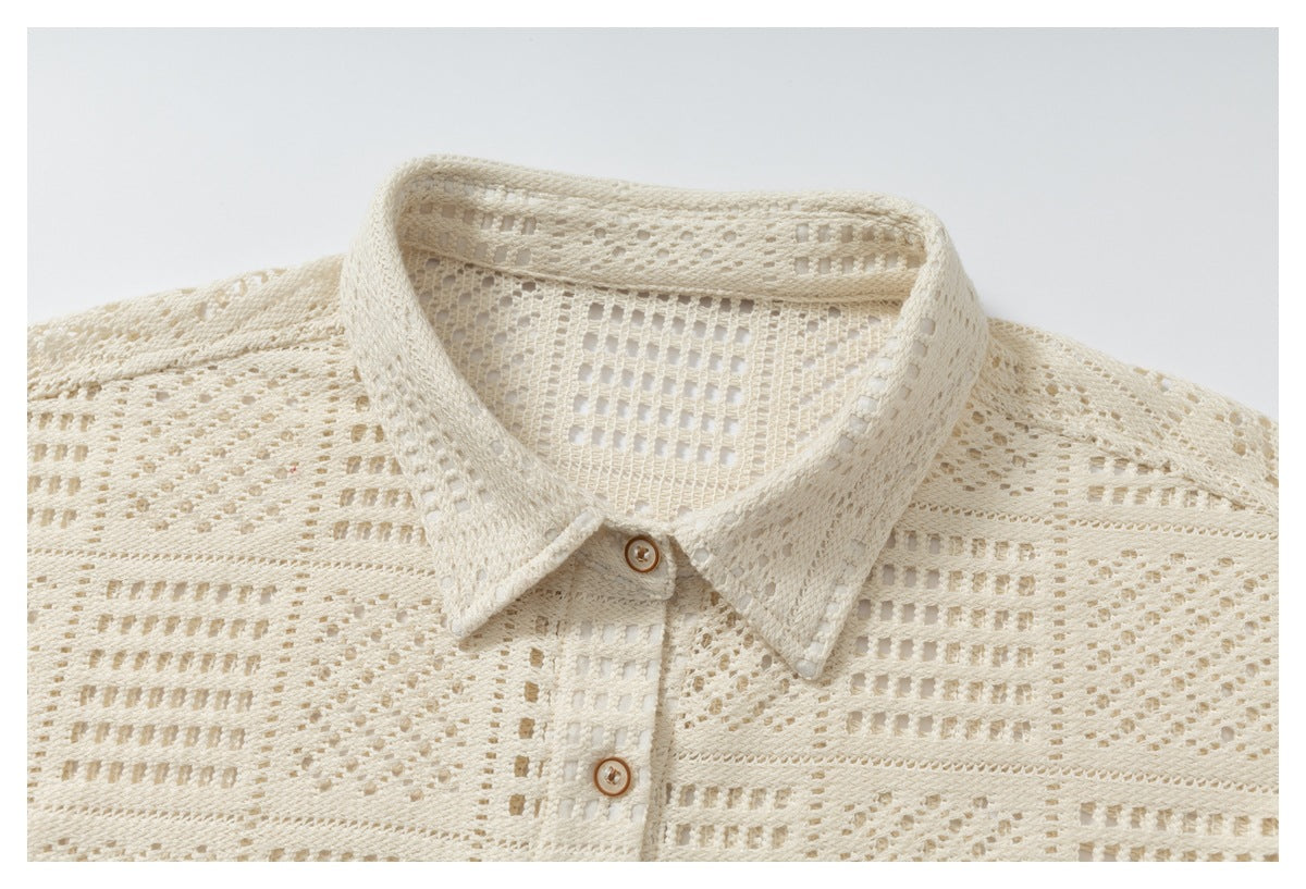 Close-up of an ivory openwork shirt collar and upper button placket.