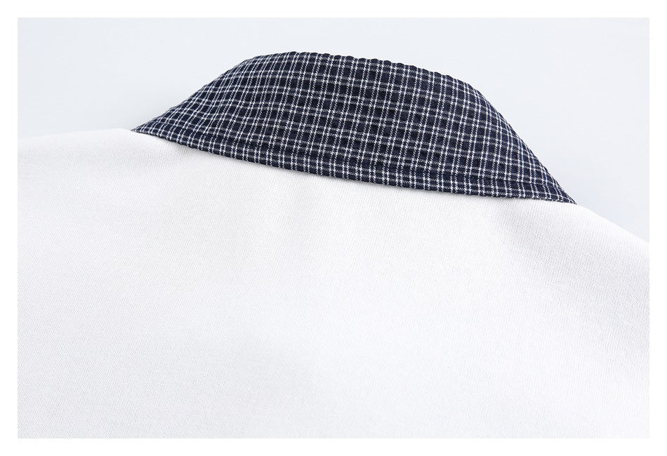 Close-up of the back neckline of a white garment with a navy checked collar.