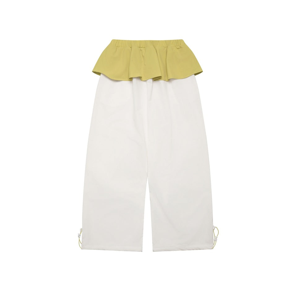 White wide-leg pants with a pale yellow-green ruffle waistband and adjustable drawcords at the hems, shown flat.