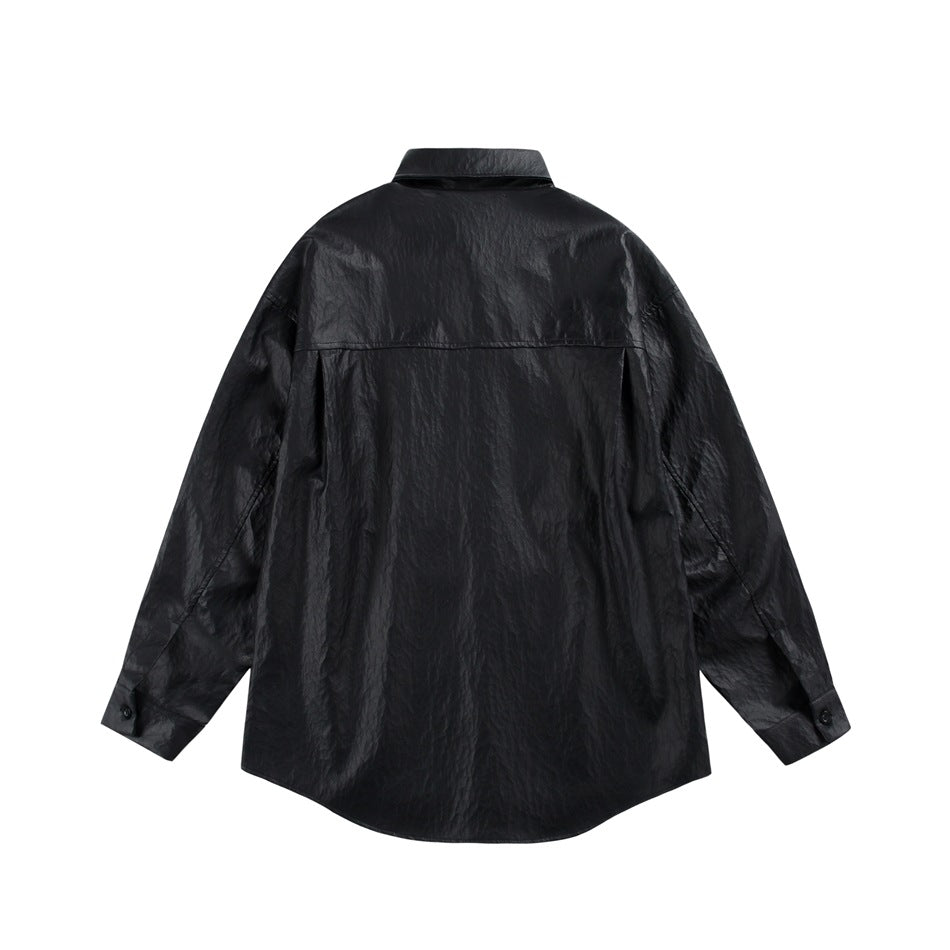 Back view of black glossy crinkled faux-leather-look shirt with back yoke seam and button cuffs