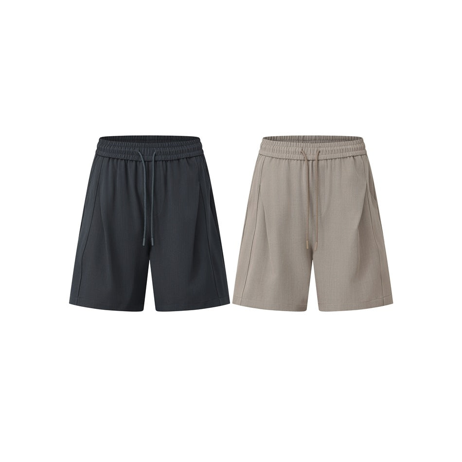 Two pairs of drawstring shorts shown from the front, one charcoal and one light taupe.