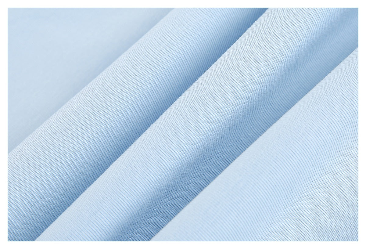 Close-up of light blue fabric arranged in folds, showing its fine ribbed texture.
