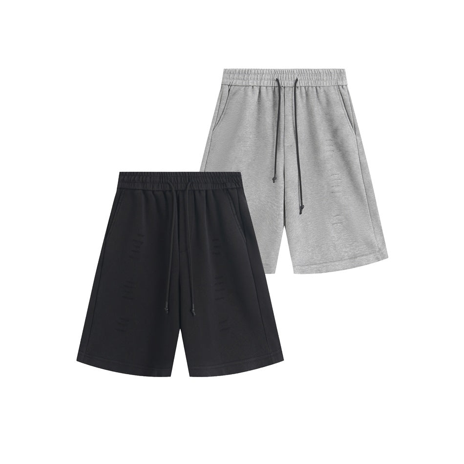 Light gray and black shorts shown together from the front, with elastic waists, drawstrings, side pockets, and wide legs.
