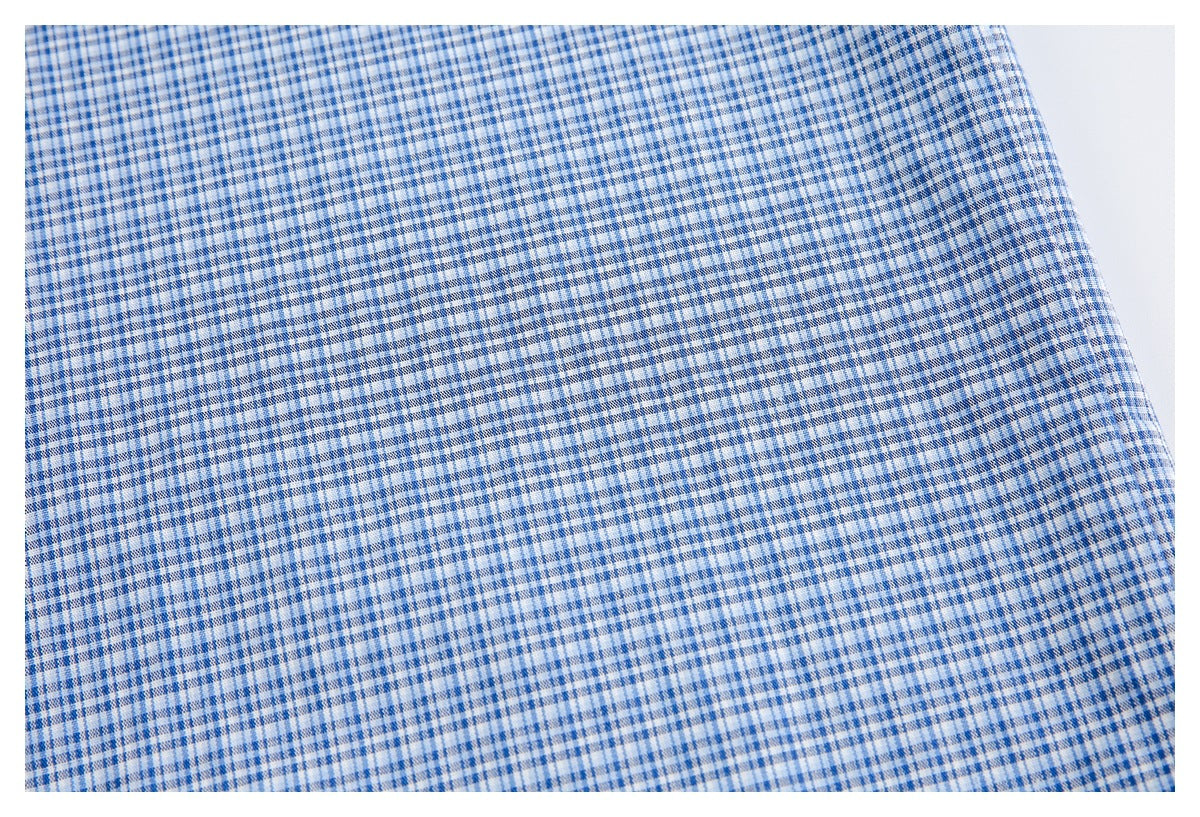 Close-up of the blue-and-white checked fabric pattern across a flat garment section.