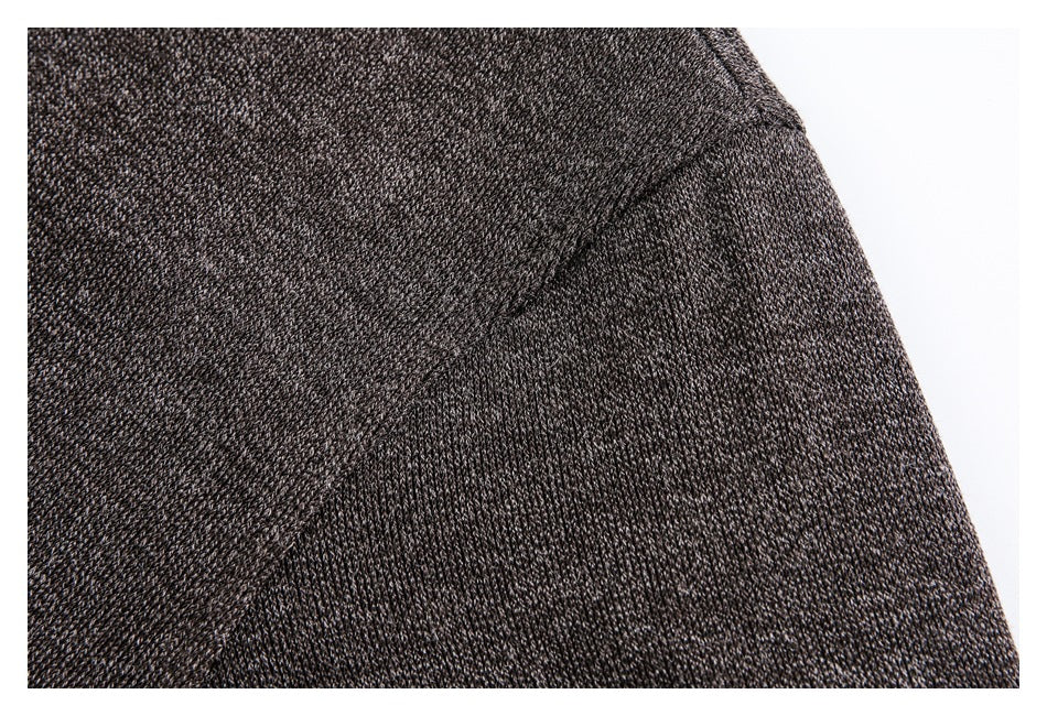 Close-up showing the dark brown jacket's textured fabric and curved shoulder seam.
