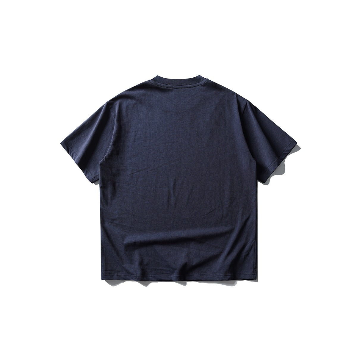 Back view of plain navy blue short-sleeve crew-neck T-shirt flat lay