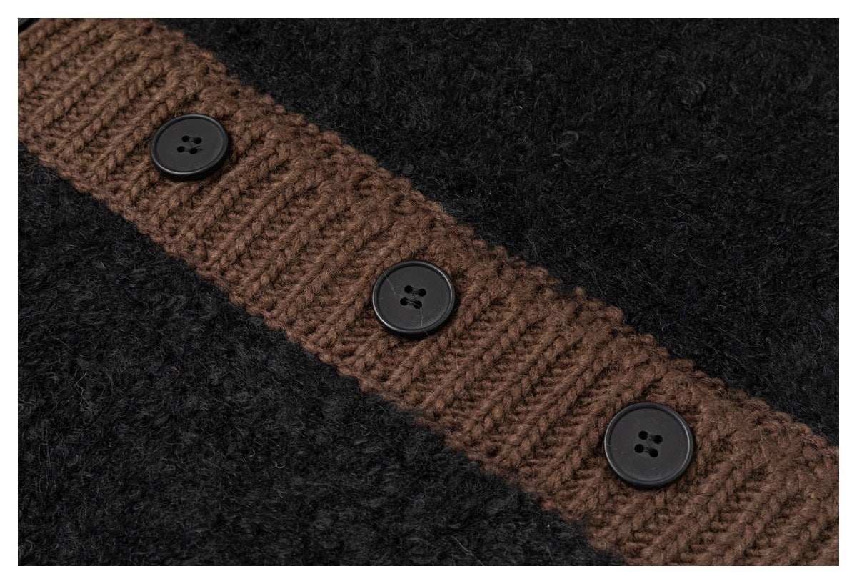 Close-up of three black buttons along the cardigan’s brown ribbed trim against fuzzy black knit.