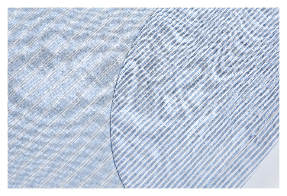 Light blue fine-striped fabric meets a contrasting blue-and-white striped panel in close-up.