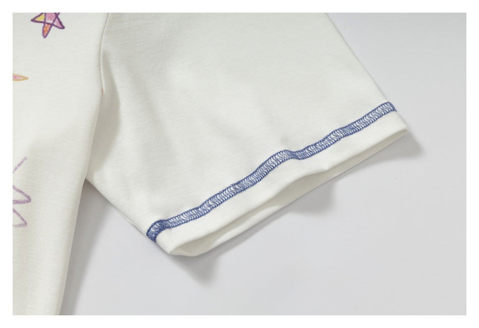 Close-up of the white shirt's short sleeve cuff with visible blue overlock stitching.