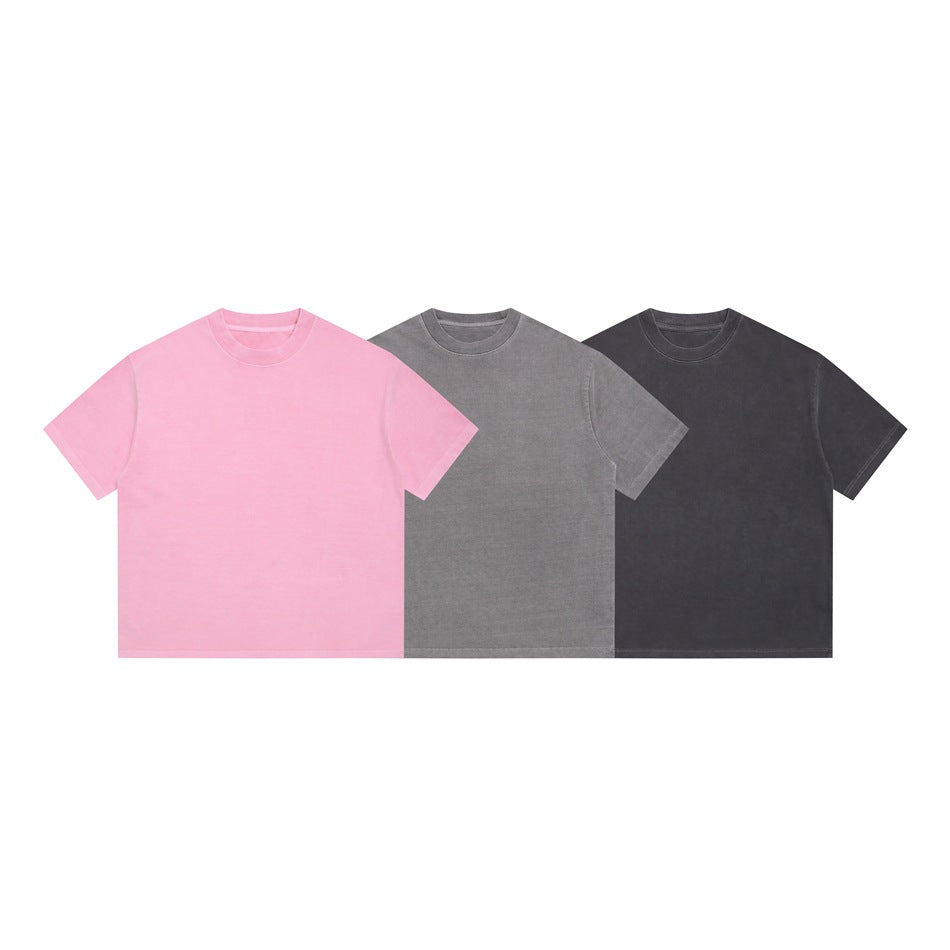 Three plain short-sleeve crew-neck T-shirts shown from the front in pink, gray, and charcoal.