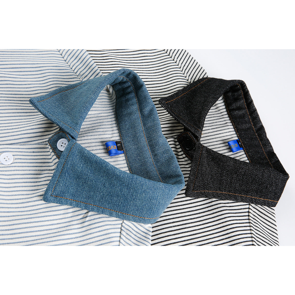 Close-up of blue and black denim-style shirt collars over fine striped fabric, with visible buttons and small blue labels.