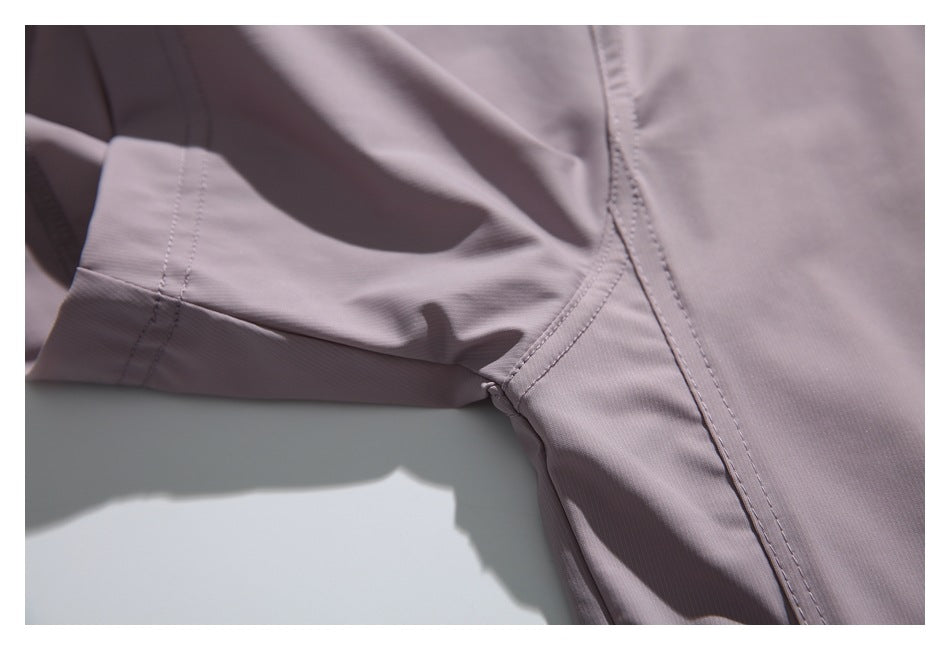 Close-up of the mauve shirt's sleeve and underarm seam stitching.