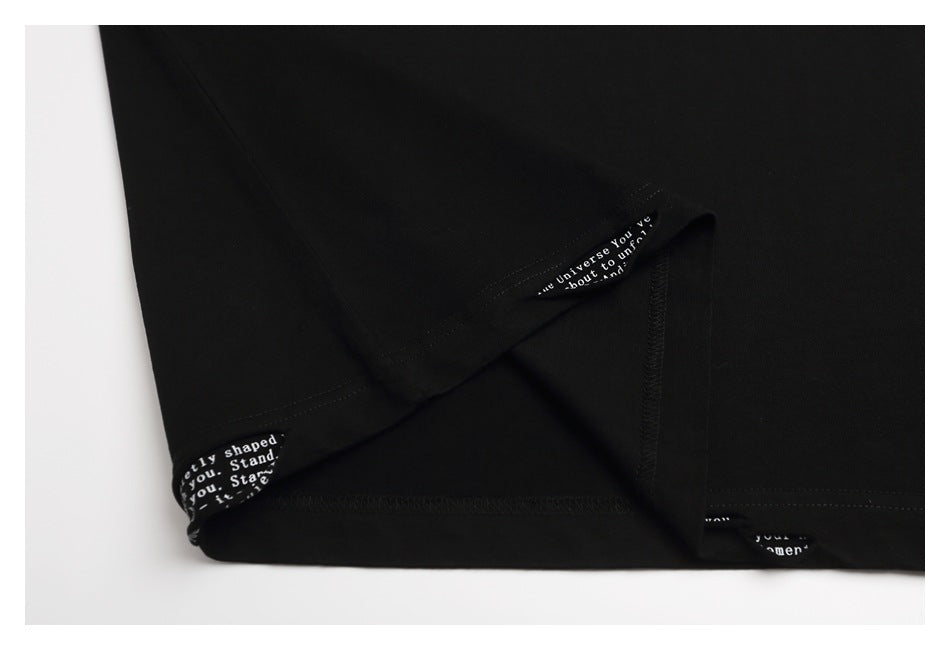 Inside hem and seam details of a black garment, with small white English text on the trim.
