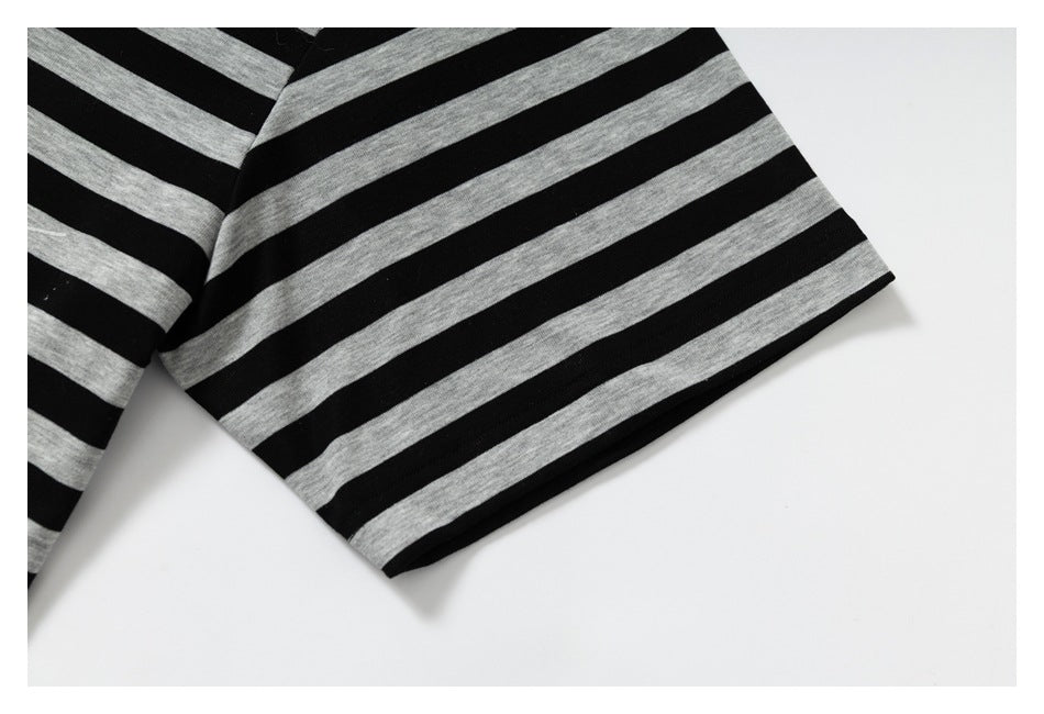 Close-up of a short sleeve showing alternating black and gray horizontal stripes.