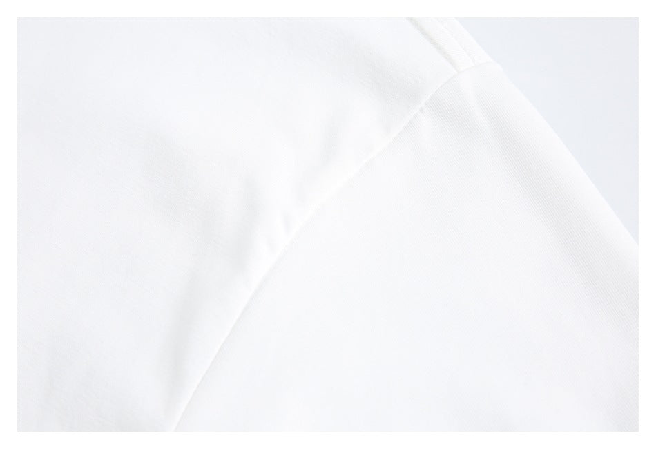 Close-up of the shoulder seam and white fabric on a T-shirt.