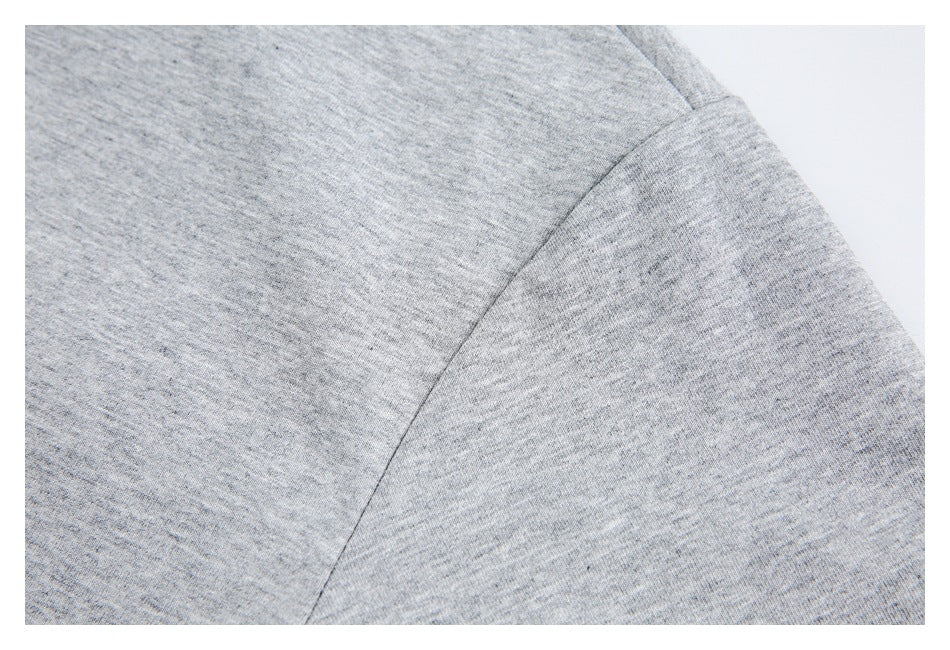 Close-up of a heather-gray shirt showing the curved shoulder seam and sleeve.