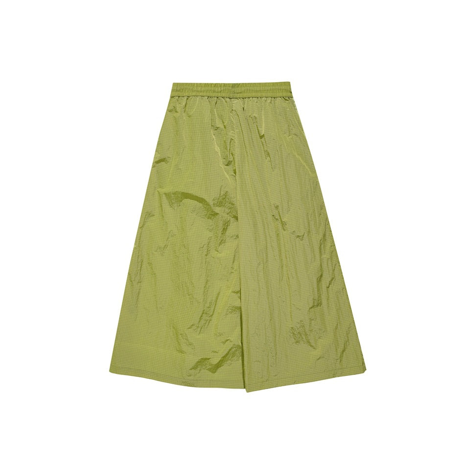 Back view of lime green wide-leg pants with a gathered elastic waistband and crinkled, subtly grid-patterned panels.