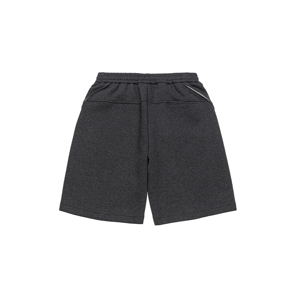 Back view of charcoal shorts with an elastic waistband, angled pocket openings, and straight hems.