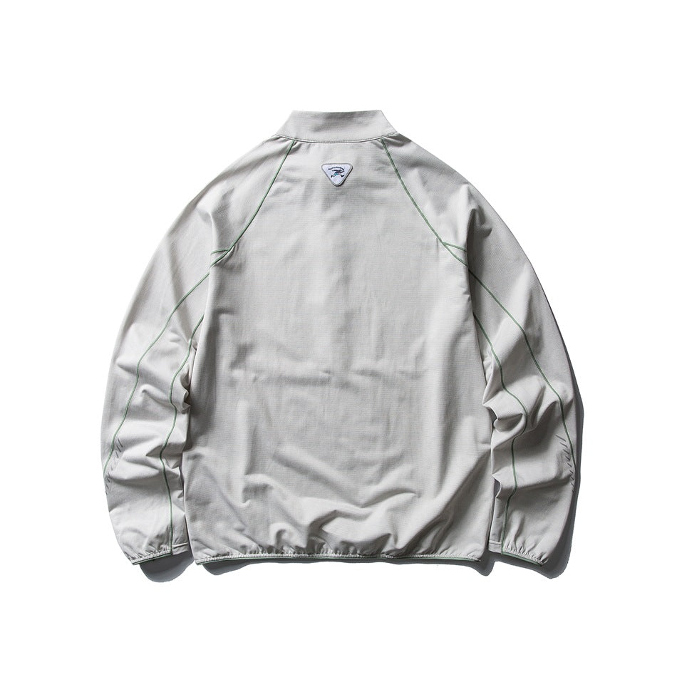 Back view of a light gray long-sleeve pullover with a stand collar and green seam piping.
