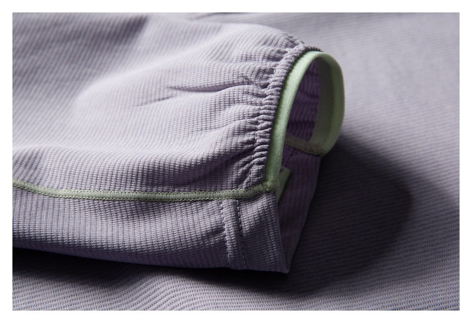 Close-up of the lavender jacket’s gathered sleeve cuff with pale green edging and seam piping.