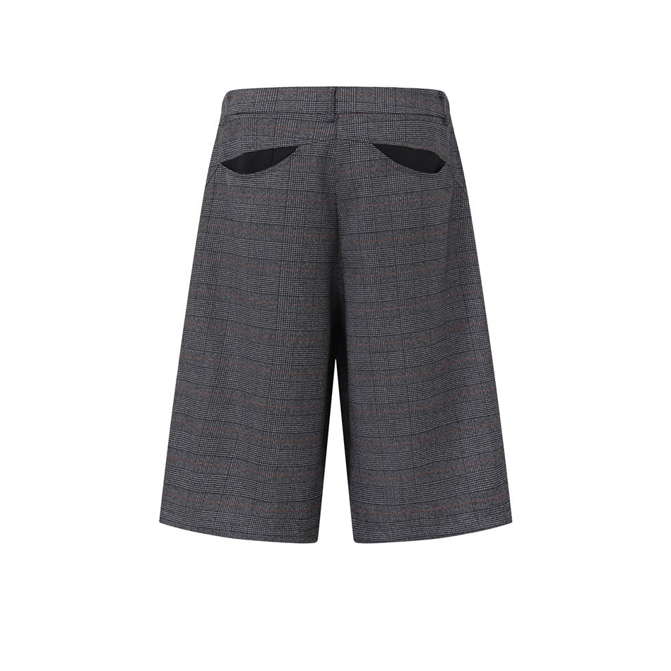 Rear view of gray plaid wide-leg shorts with curved back pocket openings and dark pocket lining.