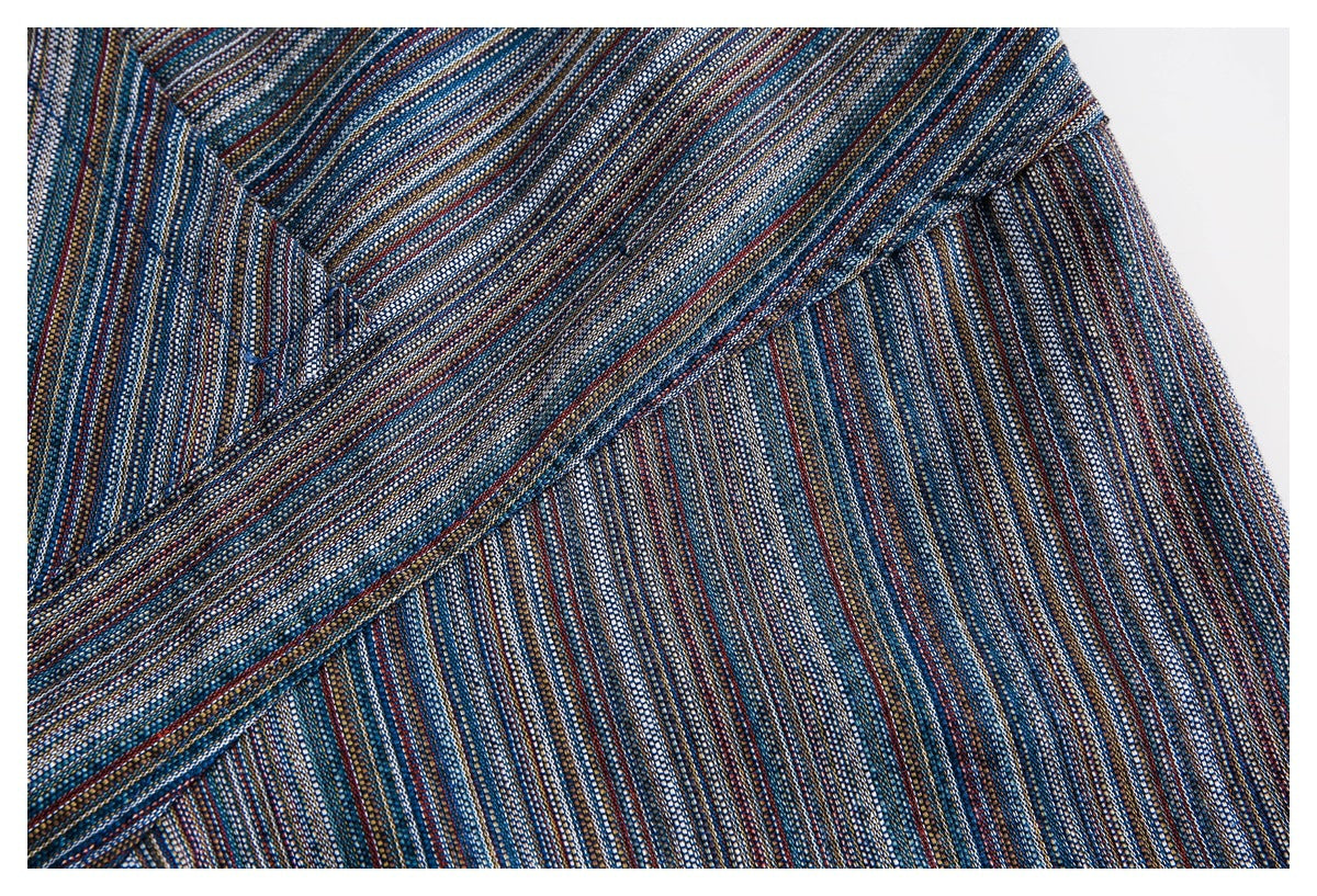Close-up showing the seam and fine multicolor stripe pattern of a dark blue shirt.
