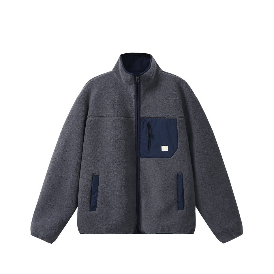 Blue-gray stand-collar zip jacket in textured fleece-like fabric with navy chest zip pocket and navy pocket trim