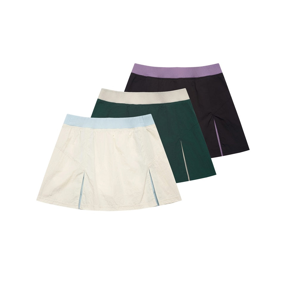 Three flared skirts shown together: ivory with a pale blue waistband, dark green with ivory, and black with lavender.