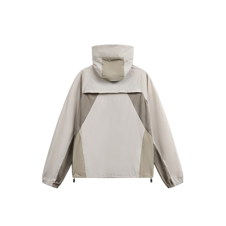 Back view of a light beige hooded jacket with taupe and gray color-block panels.