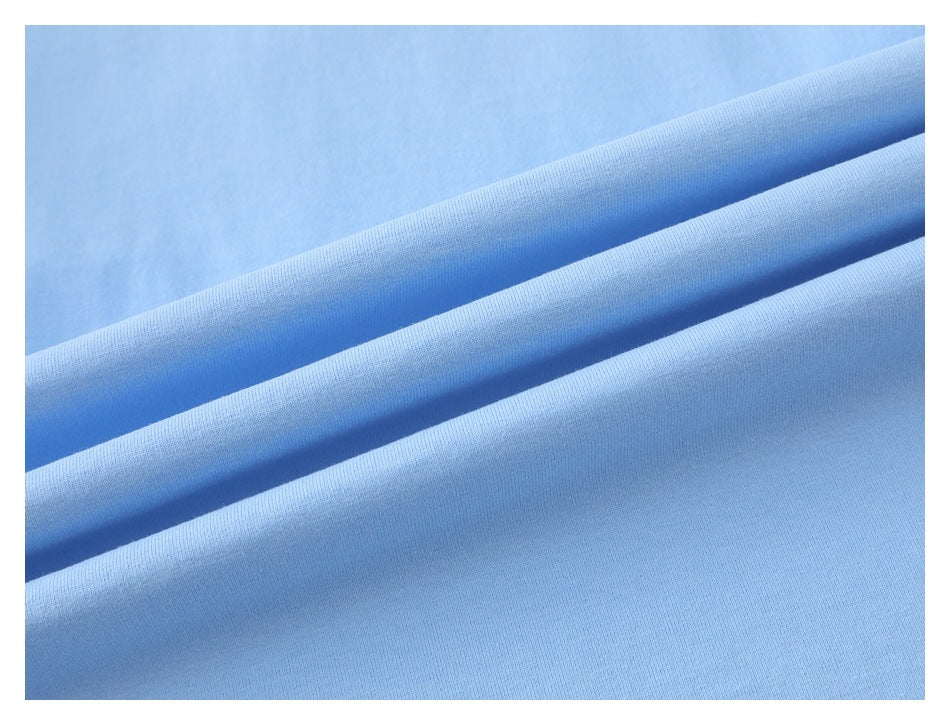 Close-up of light blue fabric draped in soft folds, showing its fine knit texture.