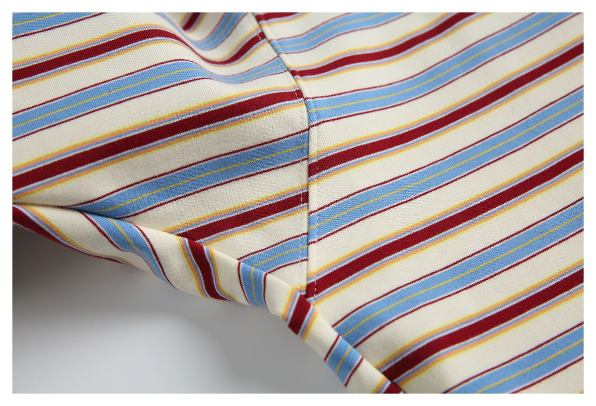 Close-up of the striped T-shirt's sleeve-to-body seam and fabric pattern.