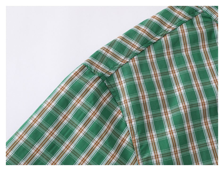 Close-up of a green, white, and brown plaid shirt showing the shoulder and sleeve seam.