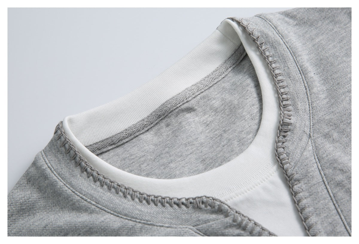 Close-up of a gray garment neckline with a white inner collar and visible stitching.