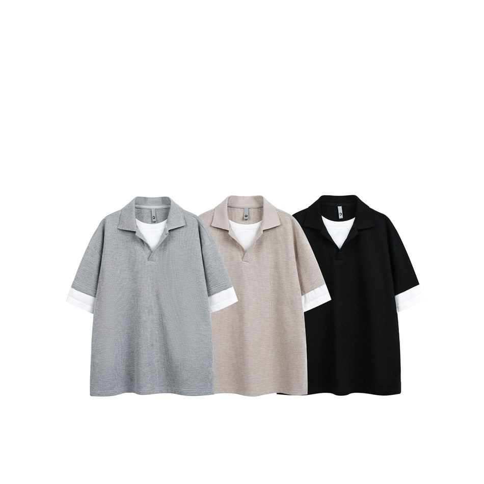 Three short-sleeve polos arranged together in gray, beige, and black, each with white sleeve cuffs.