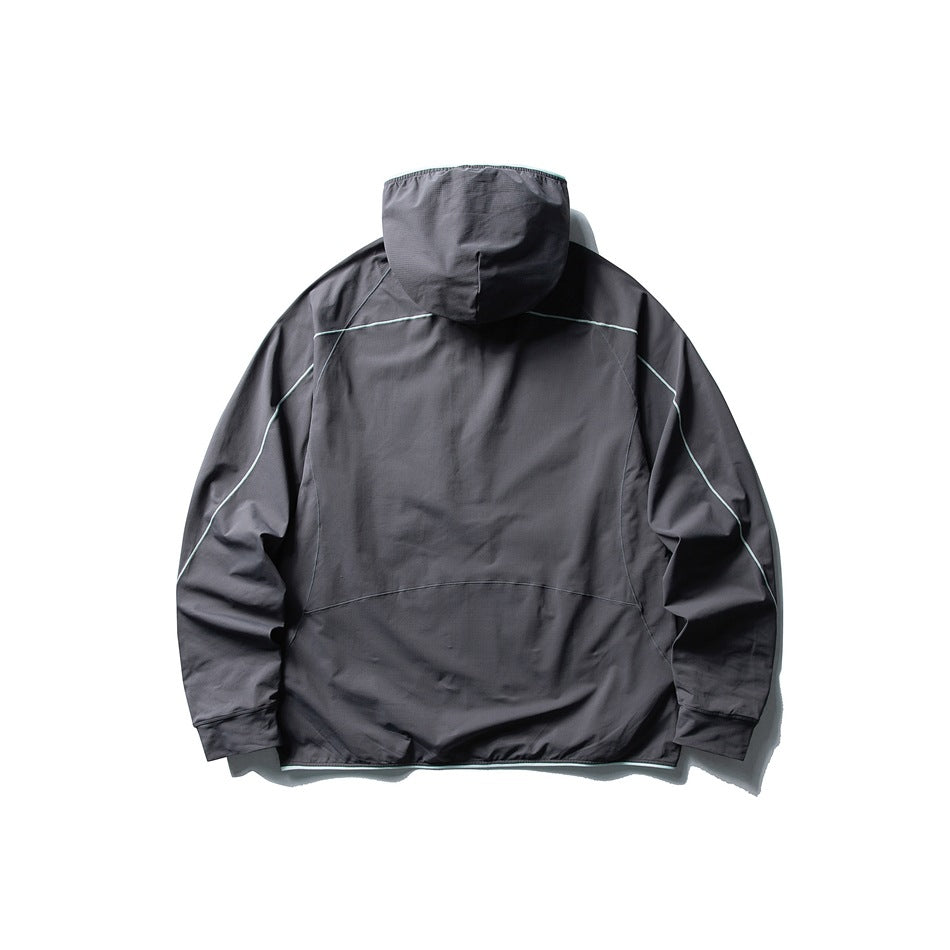 Back view of a charcoal gray hooded jacket with pale contrast piping and long sleeves, laid flat on white.