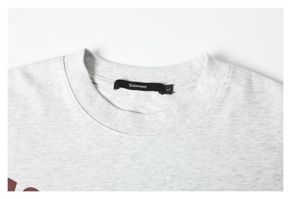 Close-up of a light gray heather T-shirt crew neck and black inner label.