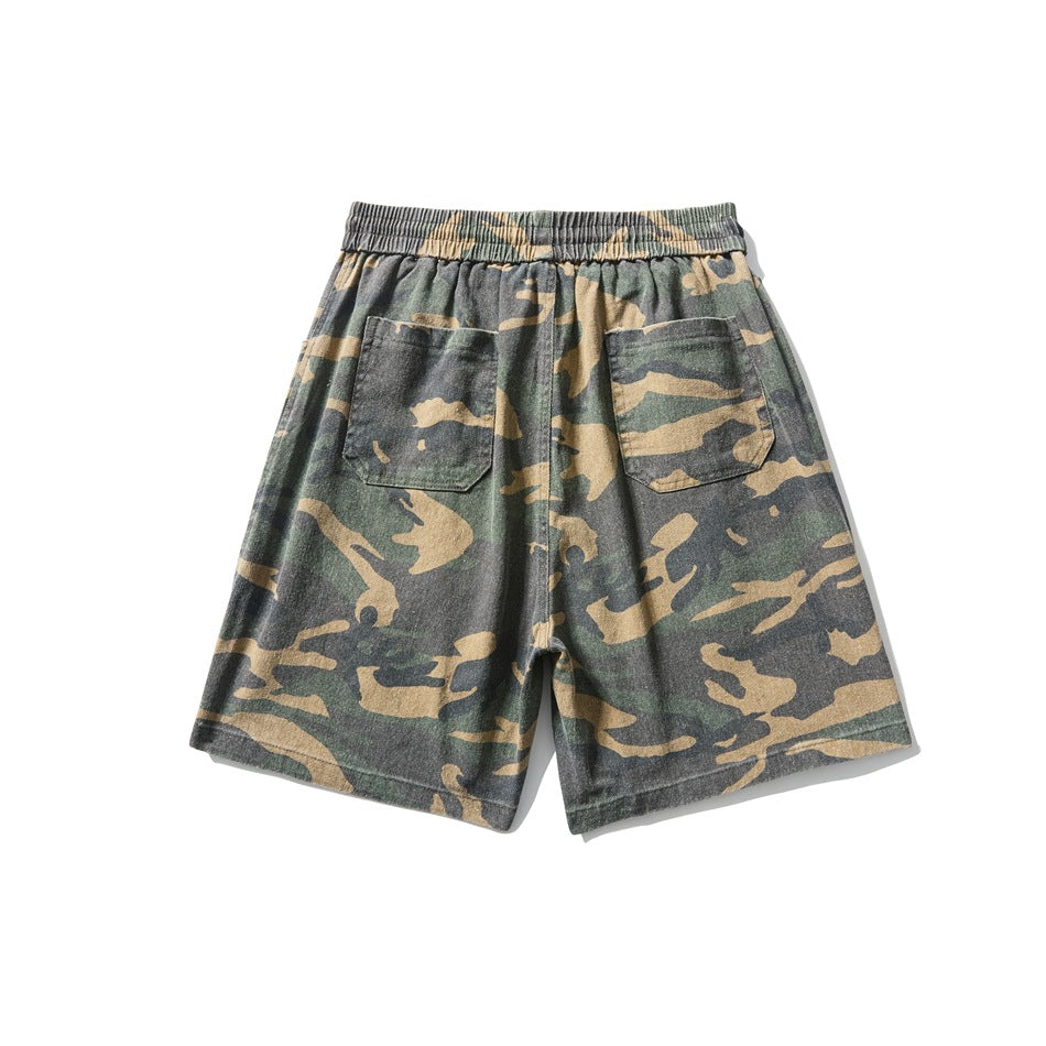 Back of camouflage shorts with elastic waistband and two patch pockets
